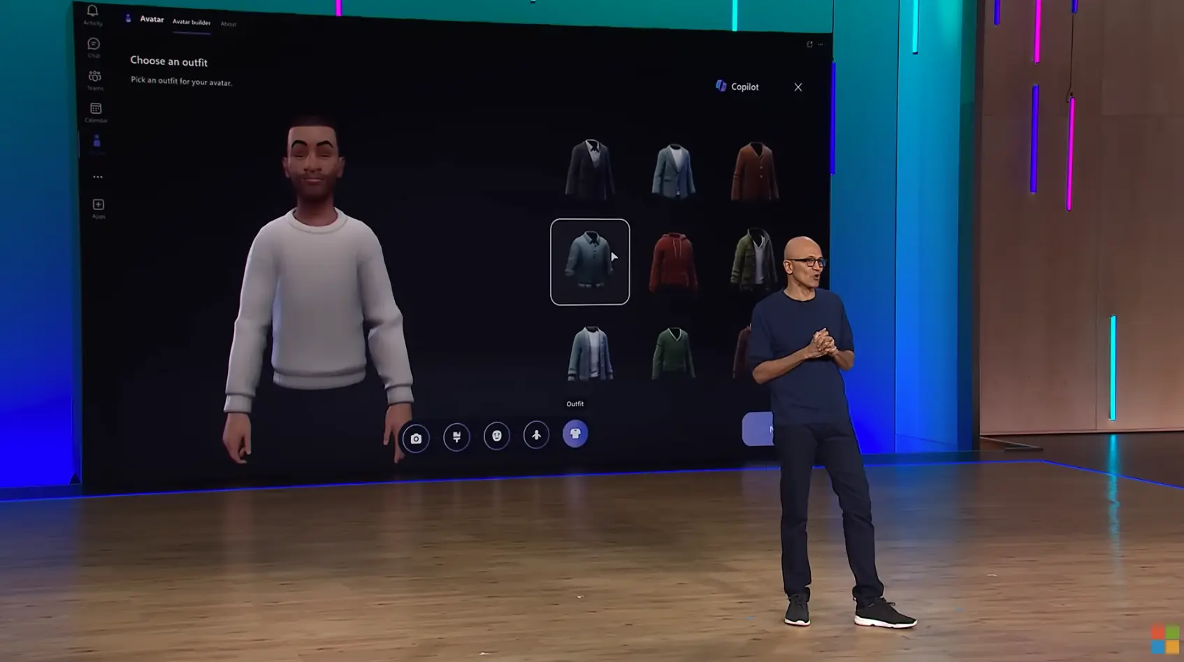 Microsoft Teams avatar builder showing the Choose an outfit step on a large screen behind Satya Nadella during a Microsoft presentation